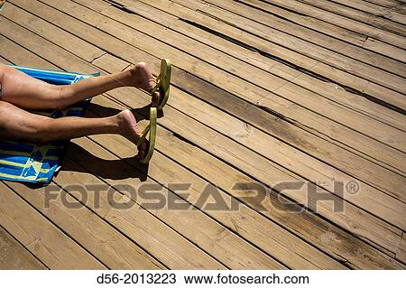 Stock Image - woman legs at the beach, Benidorm.. Fotosearch