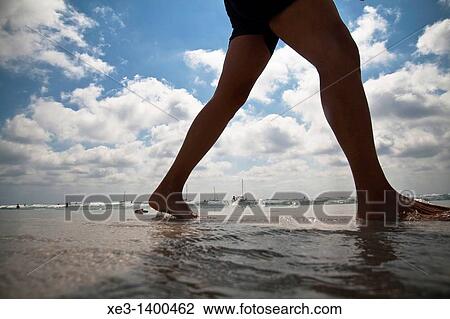 Stock Image - Woman legs at the Beach, Ibiza, Spain.. Fotosearch