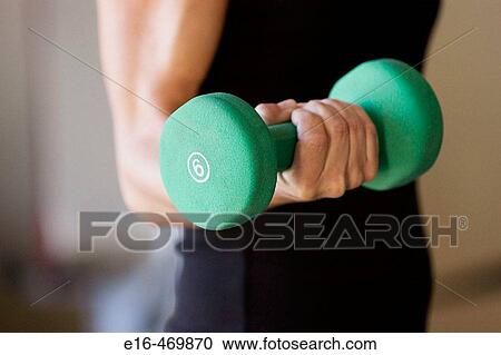 Woman lifting weights View Large Photo Image Stock Image - Woman lifting weights. Fotosearch