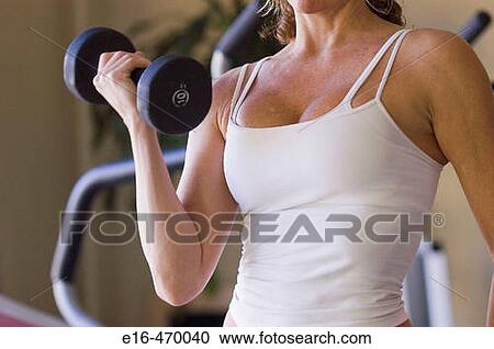 Woman lifting weights View Large Photo Image Stock Image - Woman lifting weights. Fotosearch