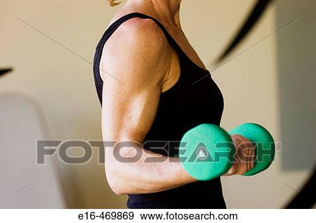 Woman lifting weights View Large Photo Image Stock Photo - Woman lifting weights. Fotosearch