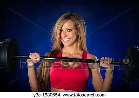 Woman lifting workout bar View Large Photo Image Picture - Woman lifting workout bar. Fotosearch