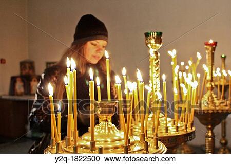Woman lighting candles at Pechersk Lavra territory, Kiev, Ukraine View Large Photo Image Stock Image - Woman lighting candles at Pechersk Lavra territory, Kiev, Ukraine. Fotosearch