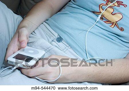 Woman listening to her Ipod. View Large Photo Image Stock Image - Woman listening to her Ipod.. Fotosearch