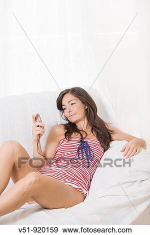 Woman listening to Mp3 at home View Large Photo Image Stock Photo - Woman listening to Mp3 at home. Fotosearch