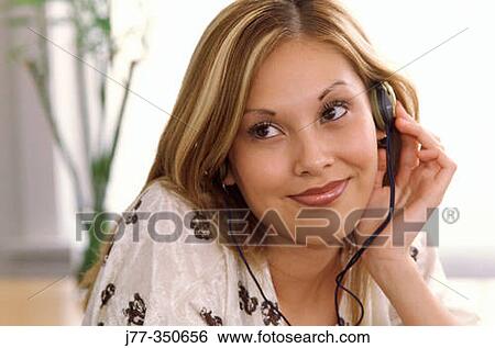 Woman listening to music View Large Photo Image Stock Photograph - Woman listening to music. Fotosearch
