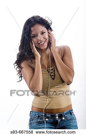 Woman listening to music with a earphones View Large Photo Image Stock Photo - Woman listening to music with a earphones. Fotosearch