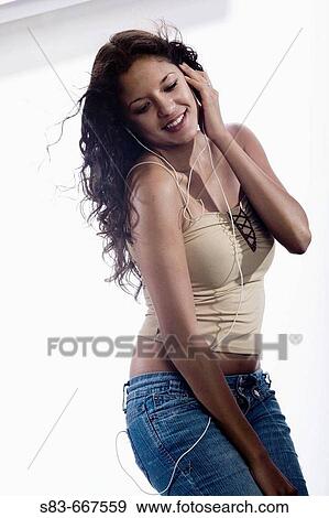 Stock Photo - Woman listening to music with a earphones. Fotosearch