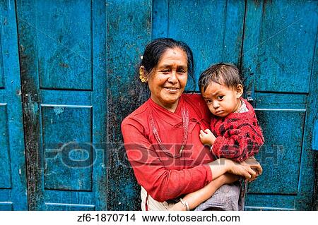 Woman local with grand child in arms in village of Bhaktapur a town near Kathmandu Nepal View Large Photo Image Picture - Woman local with grand child in arms in village of Bhaktapur a town near Kathmandu Nepal. Fotosearch
