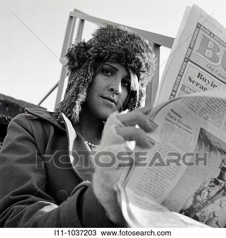 Woman looking around the side of her newpaper View Large Photo Image Stock Image - Woman looking around the side of her newpaper. Fotosearch