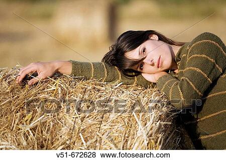 Stock Photo - Woman looking at camera in the countryside. Fotosearch