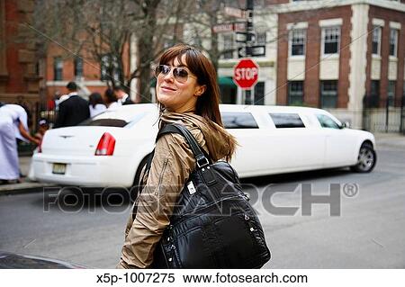 Woman looking at camera, Limousine in background View Large Photo Image Stock Photography - Woman looking at camera, Limousine in background. Fotosearch