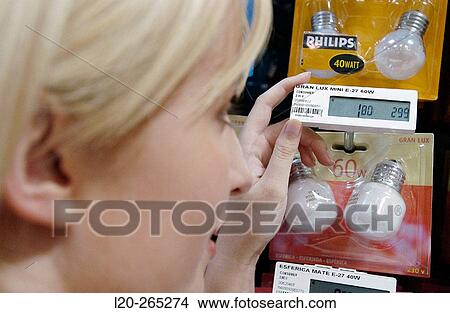 Picture - Woman looking at electronic price displays at Eroski shopping center. These displays are updated by remote control. Urbil. Usurbil. Guipuzcoa. Basque Country. Spain. Fotosearch