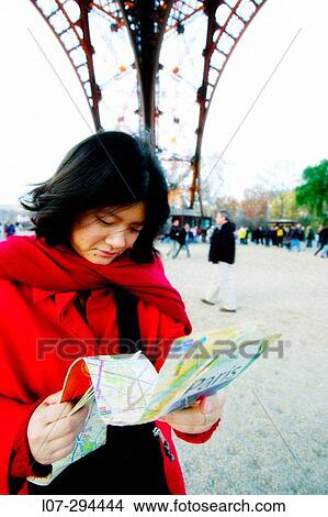 Woman looking at map under the Eiffel Tower. Paris. France View Large Photo Image Picture - Woman looking at map under the Eiffel Tower. Paris. France. Fotosearch