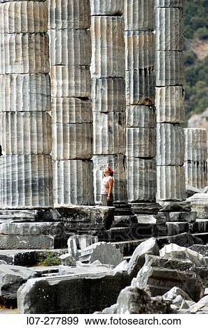 Woman looking at standing columns of Temple of Athena Polias, ruins of Priene. Turkey View Large Photo Image Stock Photo - Woman looking at standing columns of Temple of Athena Polias, ruins of Priene. Turkey. Fotosearch