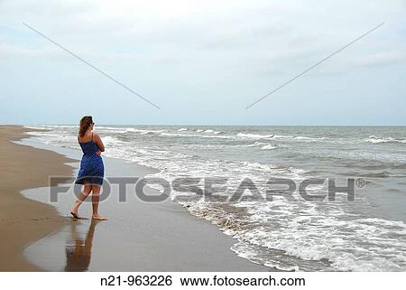 Woman looking at the horizon. El Serrallo Beach, Delta del Ebro, Tarragona, Spain. View Large Photo Image Stock Photograph - Woman looking at the horizon. El Serrallo Beach, Delta del Ebro, Tarragona, Spain.. Fotosearch