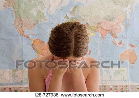 Stock Photograph - Woman Looking Down With Her Head in Her hands. Fotosearch