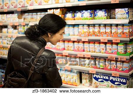Woman looking for baby food in a supermarket View Large Photo Image Stock Image - Woman looking for baby food in a supermarket. Fotosearch
