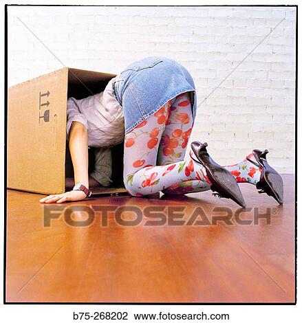 Woman looking for something in a cardboard box View Large Photo Image Stock Image - Woman looking for something in a cardboard box. Fotosearch