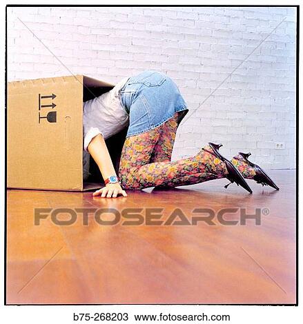 Woman looking for something in a cardboard box View Large Photo Image Stock Image - Woman looking for something in a cardboard box. Fotosearch