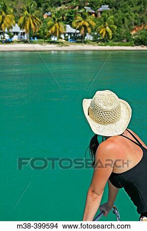 Picture - Woman looking out at the water from a catamaran. Fotosearch