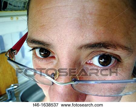 Woman looking over eyeglasses View Large Photo Image Stock Photo - Woman looking over eyeglasses. Fotosearch