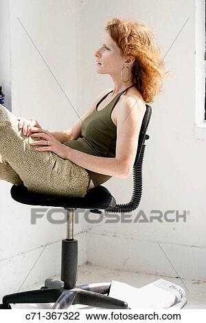Woman looking through window View Large Photo Image Stock Image - Woman looking through window. Fotosearch