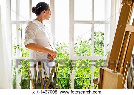 Woman looking through window View Large Photo Image Stock Photo - Woman looking through window. Fotosearch