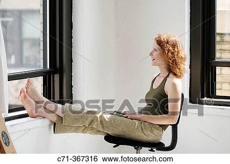 Woman looking through window View Large Photo Image Stock Photograph - Woman looking through window. Fotosearch