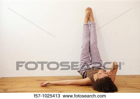 Woman lying down, legs up View Large Photo Image Stock Image - Woman lying down, legs up. Fotosearch