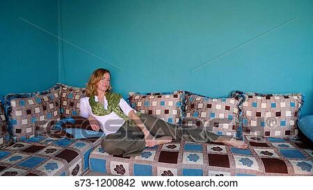 Stock Image - Woman lying in a Marrakesh room, Morocoo, Africa. Fotosearch