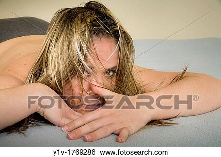 Stock Photograph - Woman lying in bed. Fotosearch