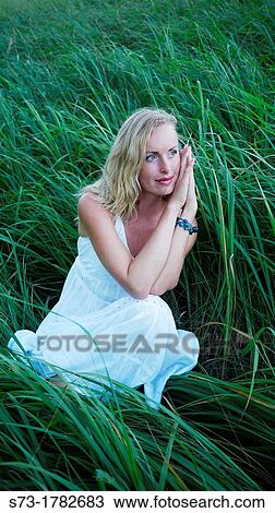 Woman lying in field View Large Photo Image Stock Image - Woman lying in field. Fotosearch