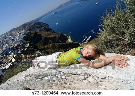 Woman lying in Santorini, Fira, Cyclades Islands, Greece View Large Photo Image Picture - Woman lying in Santorini, Fira, Cyclades Islands, Greece. Fotosearch