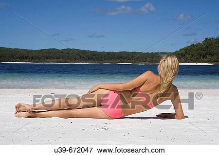 Woman lying on beach, seen from behind. Fraser Island, Australia View Large Photo Image Stock Photo - Woman lying on beach, seen from behind. Fraser Island, Australia. Fotosearch