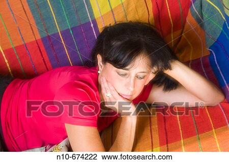 Woman lying on her sofa. View Large Photo Image Stock Image - Woman lying on her sofa.. Fotosearch