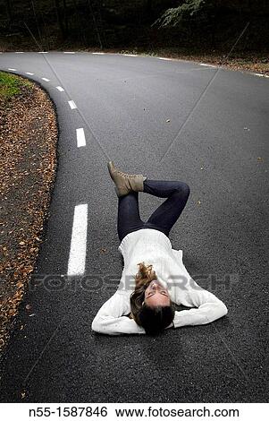 Woman lying on the road, Montseny Natural Park, Barcelona, Catalonia, Spain View Large Photo Image Stock Photograph - Woman lying on the road, Montseny Natural Park, Barcelona, Catalonia, Spain. Fotosearch