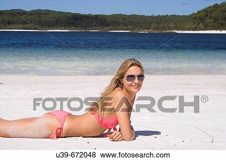 Woman lying on white beach, smiling at camera. Fraser Island, Australia View Large Photo Image Stock Photo - Woman lying on white beach, smiling at camera. Fraser Island, Australia. Fotosearch