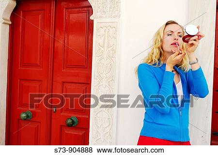 Stock Photo - Woman make up in Mykonos Island street, Cyclades, Greece. Fotosearch