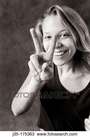 Woman makes? Peace? sign with fingers View Large Photo Image Stock Image - Woman makes? Peace? sign with fingers. Fotosearch