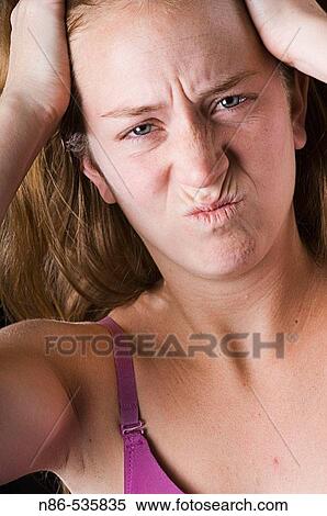 Woman making frustrated face in mirror View Large Photo Image Stock Photography - Woman making frustrated face in mirror. Fotosearch