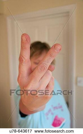 Stock Photo - Woman making impolite V sign. Fotosearch