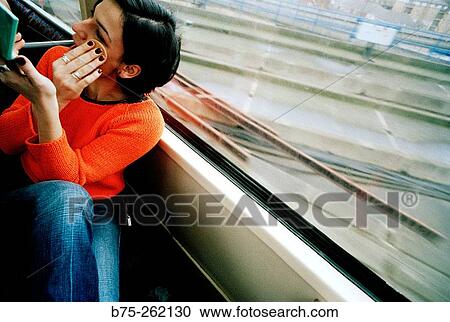 Woman making up in the train View Large Photo Image Stock Image - Woman making up in the train. Fotosearch