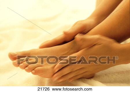 Woman massaging feet View Large Photo Image Stock Photograph - Woman massaging feet. Fotosearch