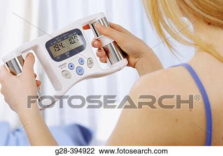 Woman measuring her fat mass weight View Large Photo Image Stock Image - Woman measuring her fat mass weight. Fotosearch