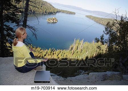 Woman mediating above a lake View Large Photo Image Picture - Woman mediating above a lake. Fotosearch