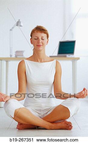Woman meditating in the office View Large Photo Image Stock Image - Woman meditating in the office. Fotosearch