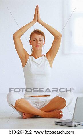Woman meditating in the office View Large Photo Image Stock Image - Woman meditating in the office. Fotosearch