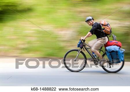 woman, middle-aged, rides a bicycle on a country road View Large Photo Image Stock Image - woman, middle-aged, rides a bicycle on a country road. Fotosearch