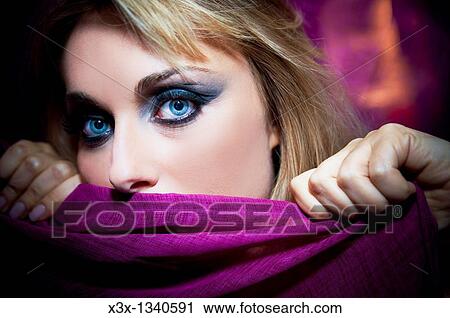 Woman model with makeup holding a purple scarf View Large Photo Image Stock Image - Woman model with makeup holding a purple scarf. Fotosearch
